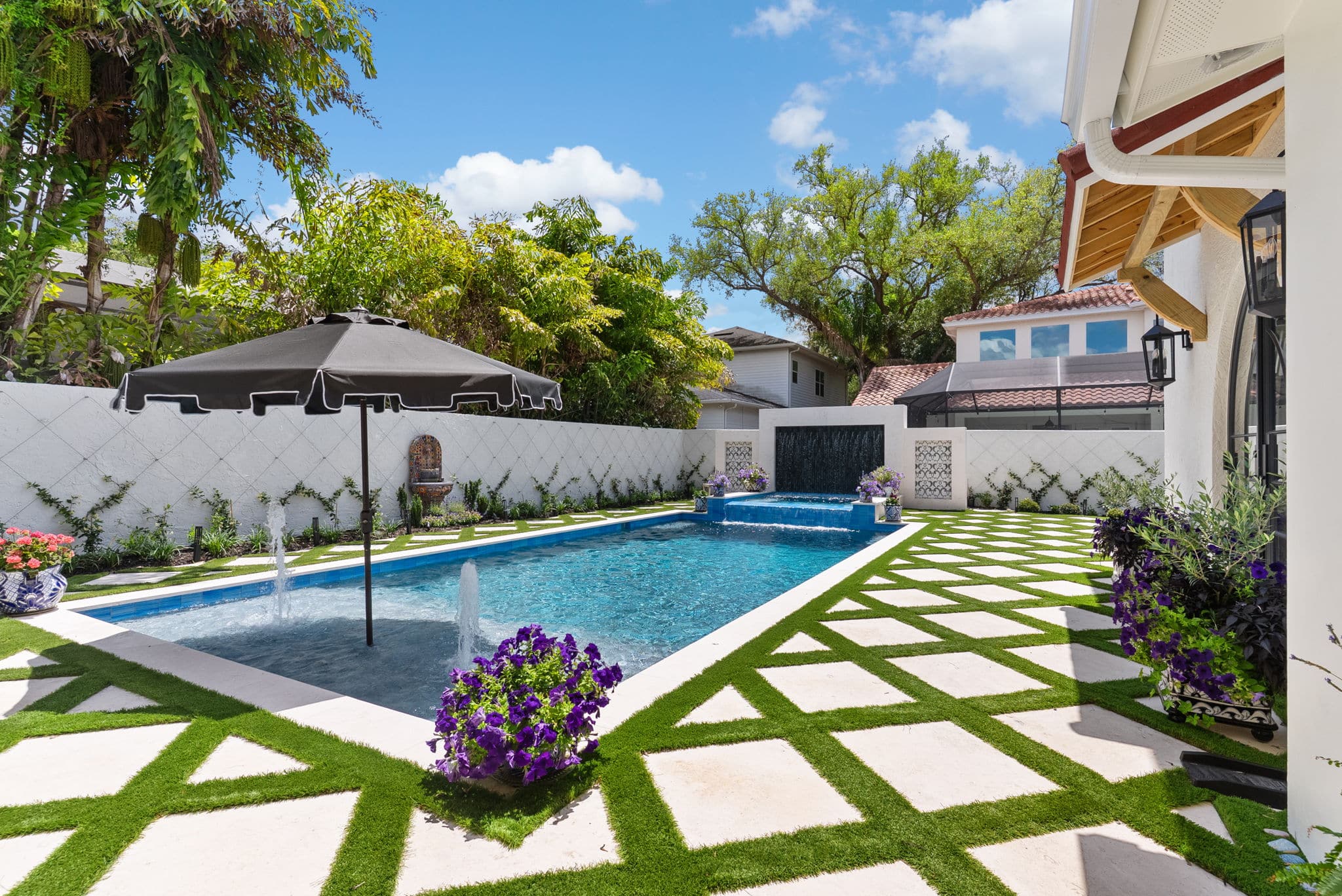 Luxury backyard pool with fountain and patio