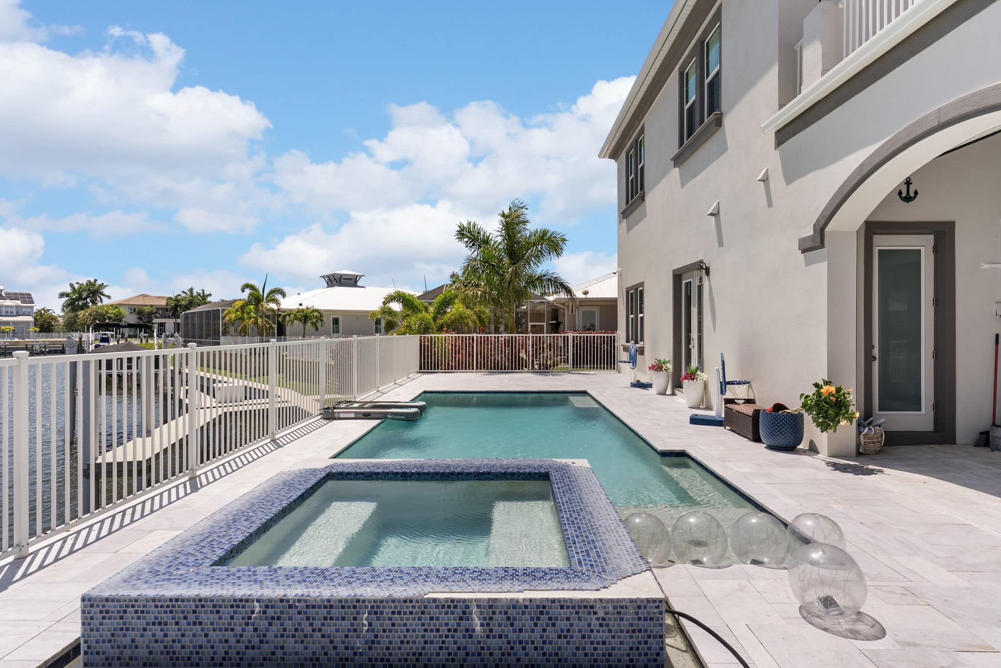 Waterfront home with pool and hot tub